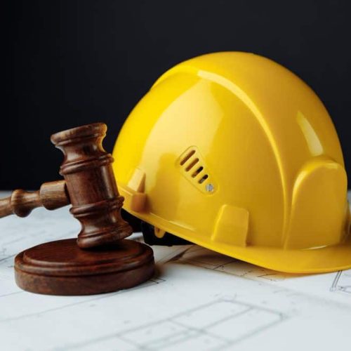 wooden-gavel-yellow-helmet-with-construction-plans (1)